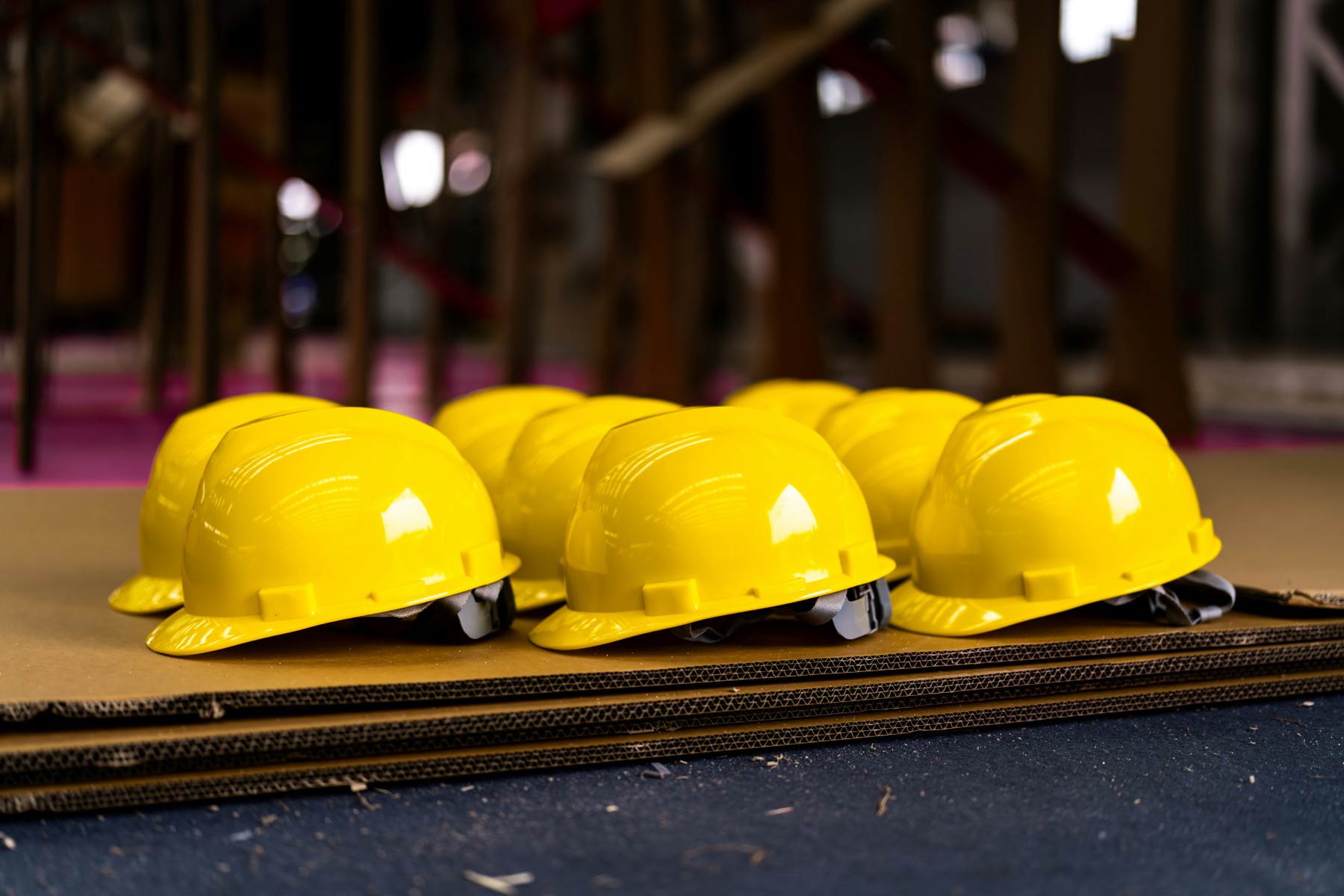 Bright yellow hard hats arranged in a row