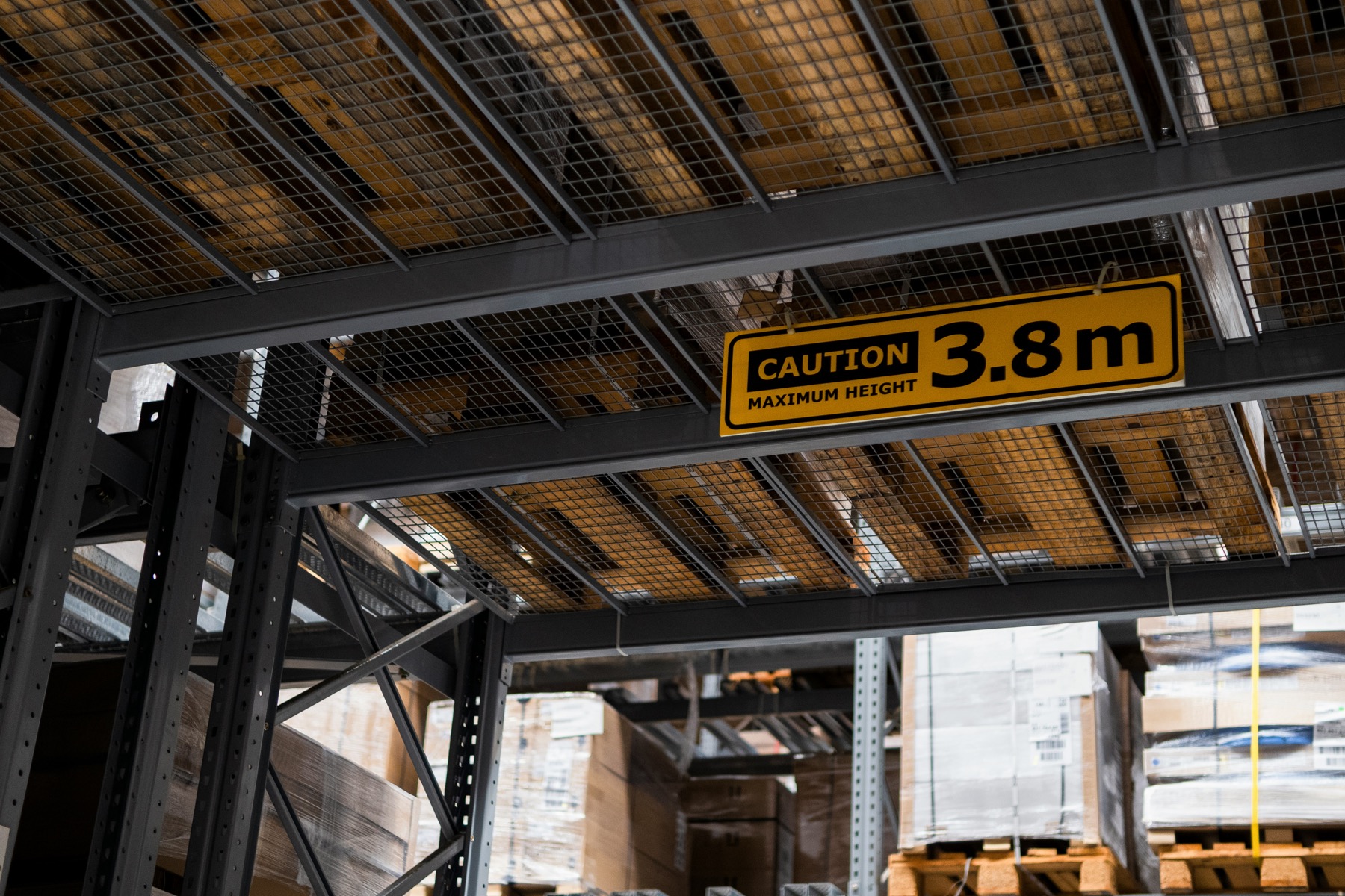 Caution height sign in a warehouse aisle